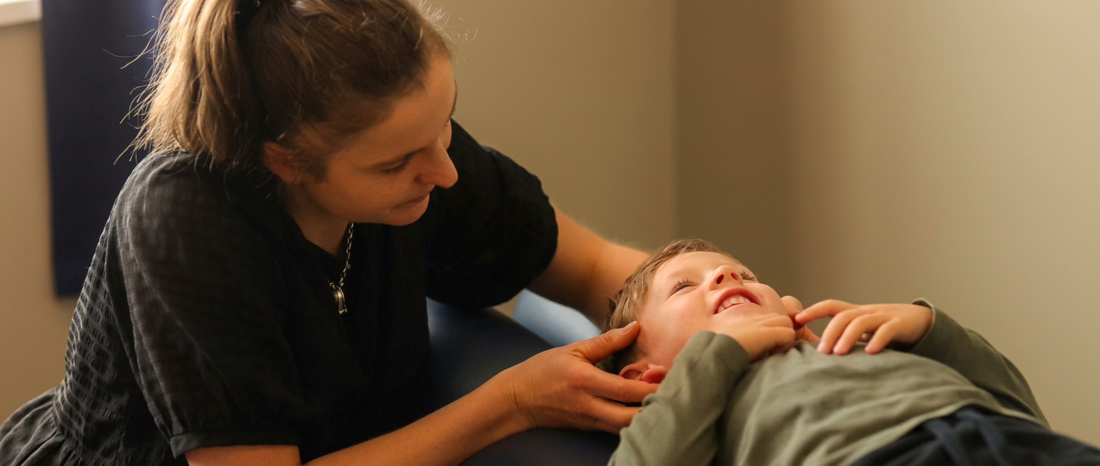 Kate adjusting a young patient at The Wellness Hub NZ